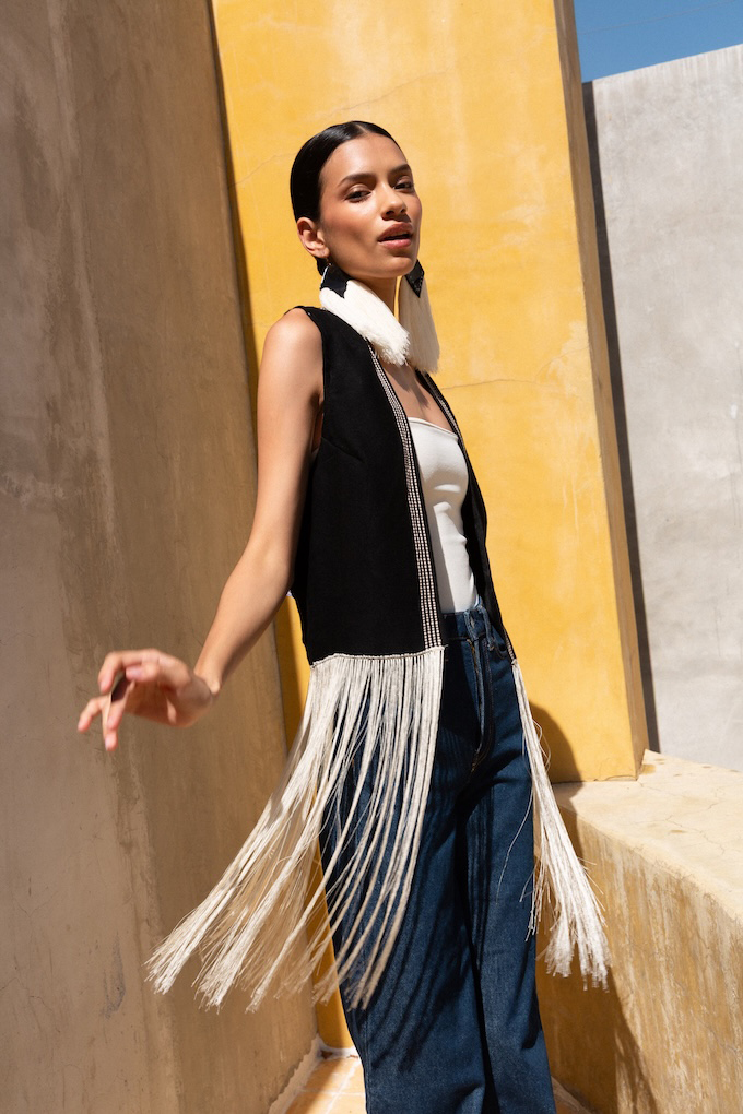 Model wearing the Agave Fringe Vest with long hand-stitched fringe, styled over wide-leg denim and a minimal top.