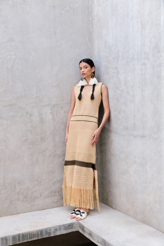 Woman wearing the Cacao crochet maxi dress with intricate knit patterns and fringe hem, handcrafted by artisans in Jalisco