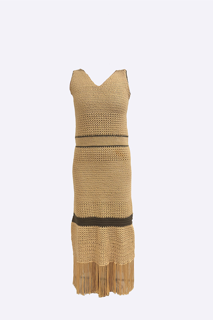 Cacao crochet maxi dress shown front-facing, highlighting its layered crochet stitches, contrast bands, and long fringe detail.
