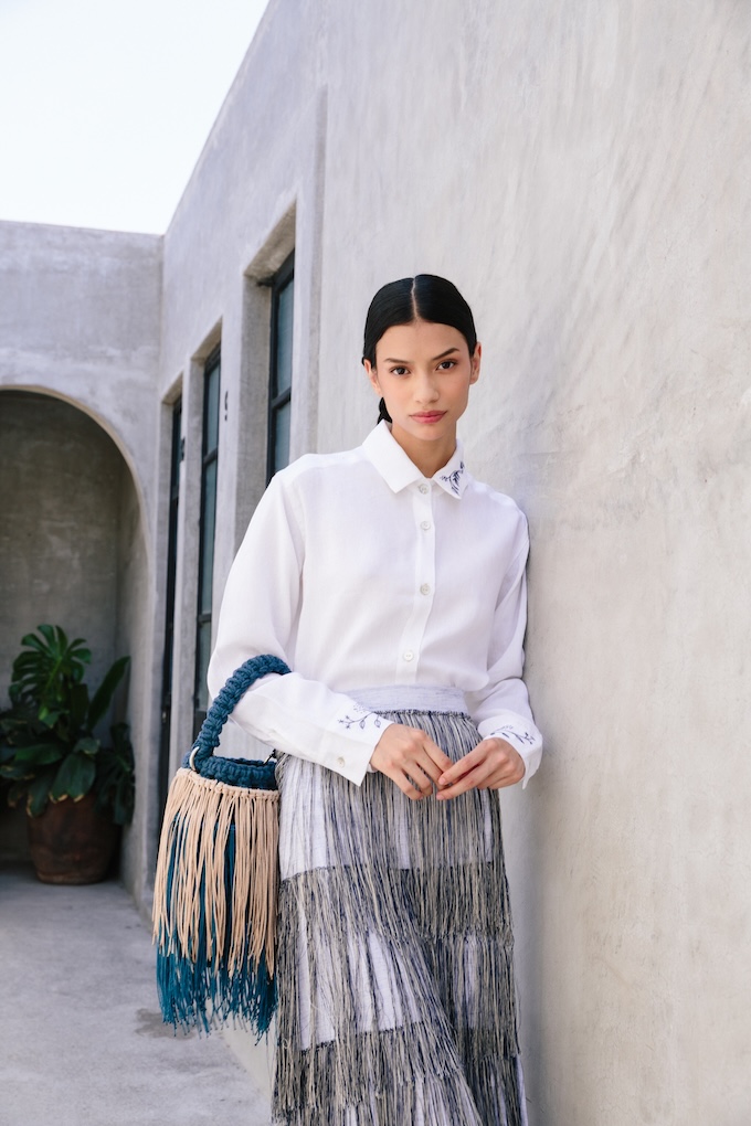 Model wearing the Hiedra embroidered linen shirt in white Italian linen with green embroidery, inspired by ivy and handcrafted in Temoaya