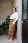 Model wearing the Tule Fringe Maxi Skirt with tiered fringe design, handcrafted by artisans in Chiapas, styled with embroidered blouse.