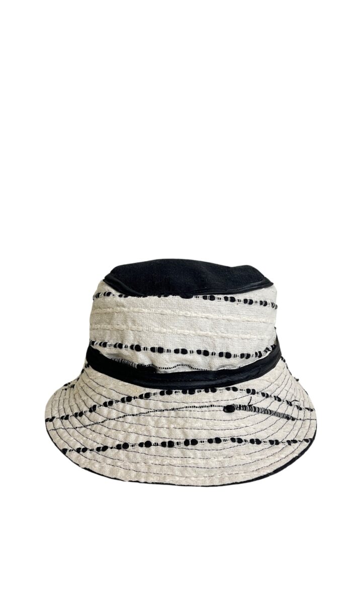Flat lay of the Monarca Bucket Hat showing the caterpillar-inspired woven texture.