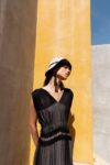 Model wearing the Monarca Bucket Hat handmade in Oaxaca, styled with the Mezcal dress.