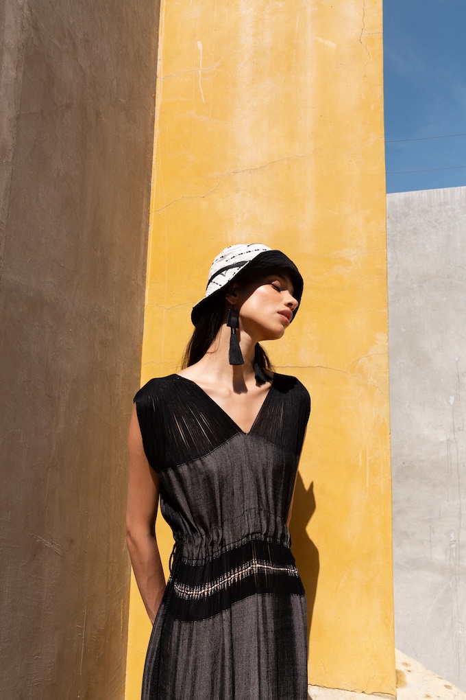 Model wearing the Monarca Bucket Hat handmade in Oaxaca, styled with the Mezcal dress.