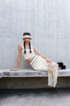 Tequila 2 Model wears the Tequila crochet midi skirt with the matching crop top. Handwoven texture and fringe shown in movement.